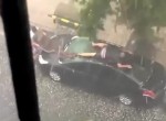 Man Desperately Tries To Protect His Car From Hail